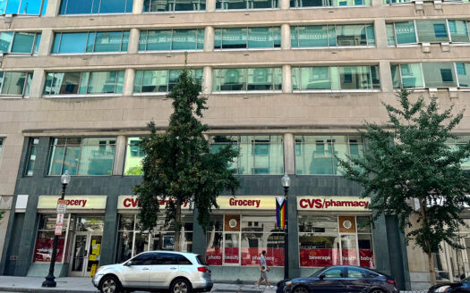 Close-up view of the CVS Pharmacy storefront at 717 14th Street NW with large glass windows and prominent street frontage.