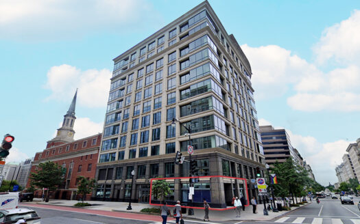 Street view of 1399 New York Avenue NW in Washington, DC, highlighting the corner retail space available at the base of a modern glass and stone office building.