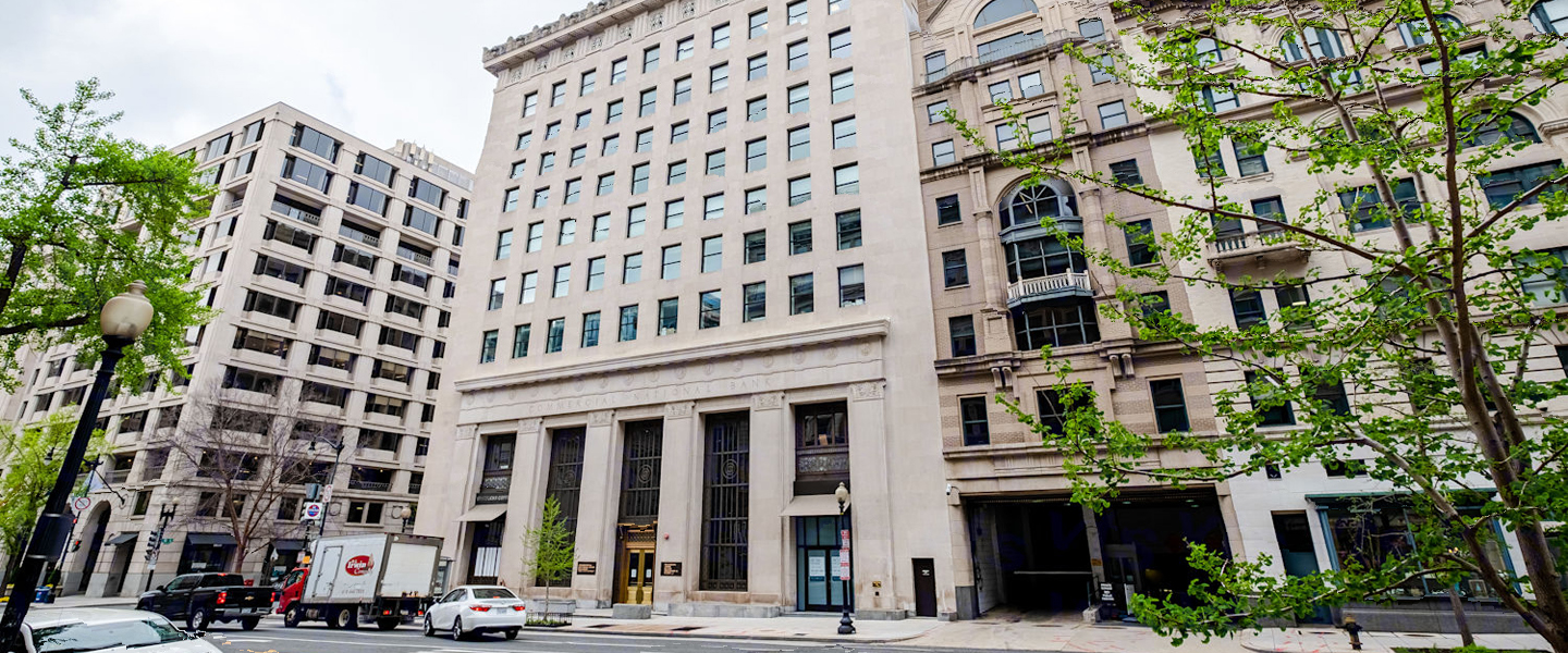 Front elevation of 700 14th Street NW in Washington DC with detailed architectural façade and street-level activity.
