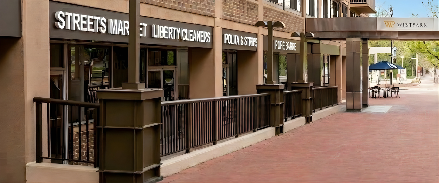 Retail storefront at 2130 P Street NW in Dupont Circle Washington DC featuring Streets Market, Liberty Cleaners, Polka & Stripes, and Pure Barre.
