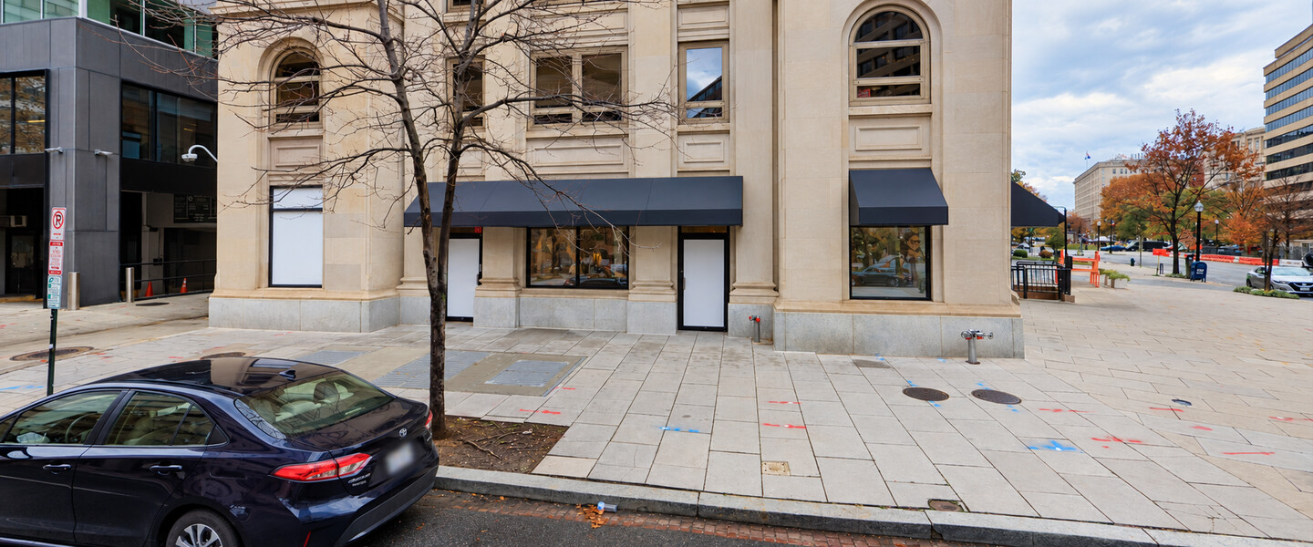 Ground-floor storefront windows and entrances along L Street at 1029 Vermont Avenue NW, Washington, DC.